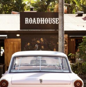 Front image of The Roadhouse, Byron Bay with an old car parked out front