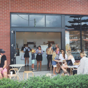 Front image of Watson Bloom Cafe with people sitting at tables out the front