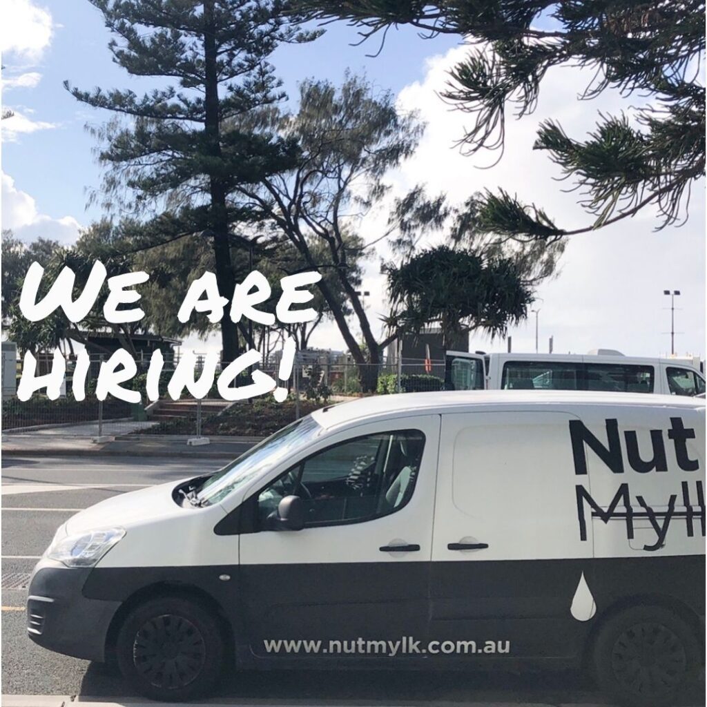 NUTMYLK van parked in front of beach with "we are hiring" on photo